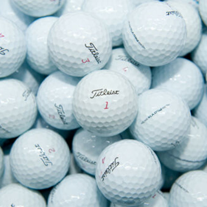 A pile of white Titleist Pro V1x golf balls with various serial numbers visible.