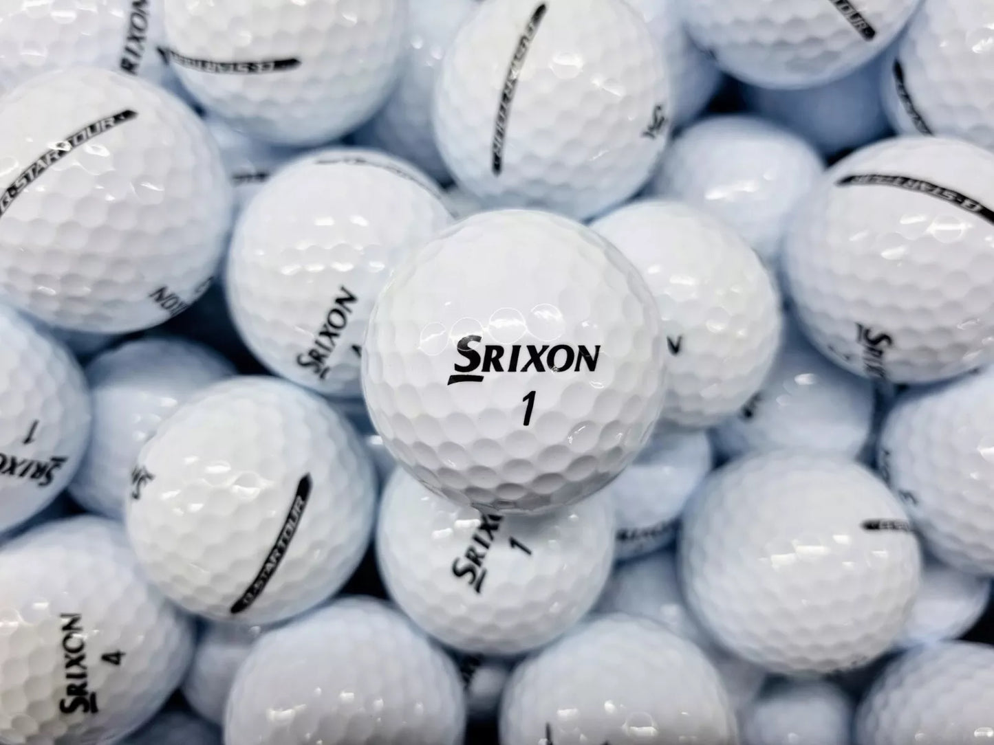 A pile of white Srixon Q-Star golf balls with minor cosmetic marks.